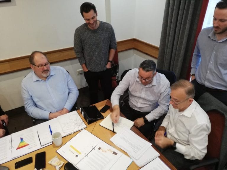 Senior managers reviewing documents together during a Plan Grow Do session
