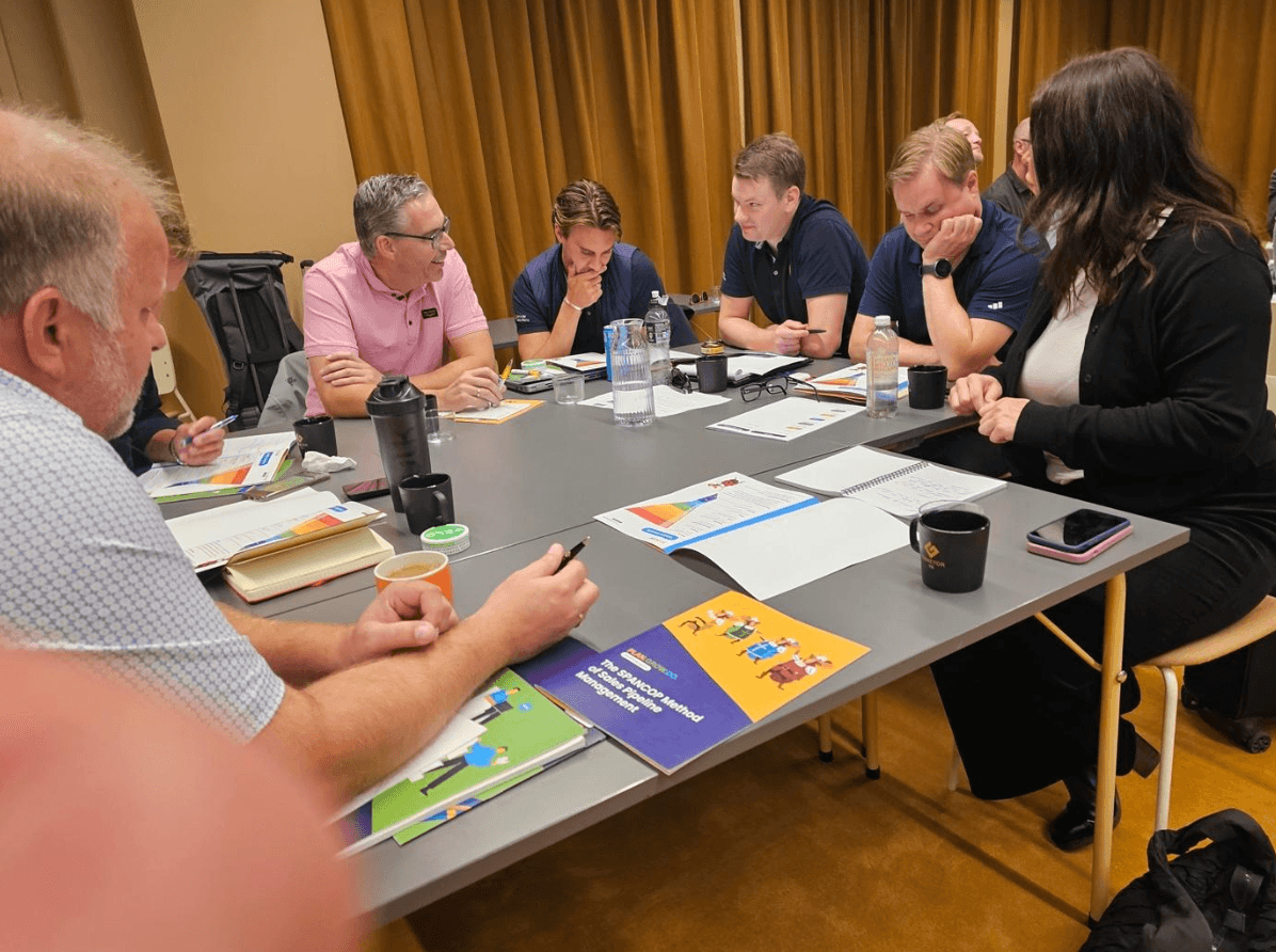A sales team working through their Core training workbooks